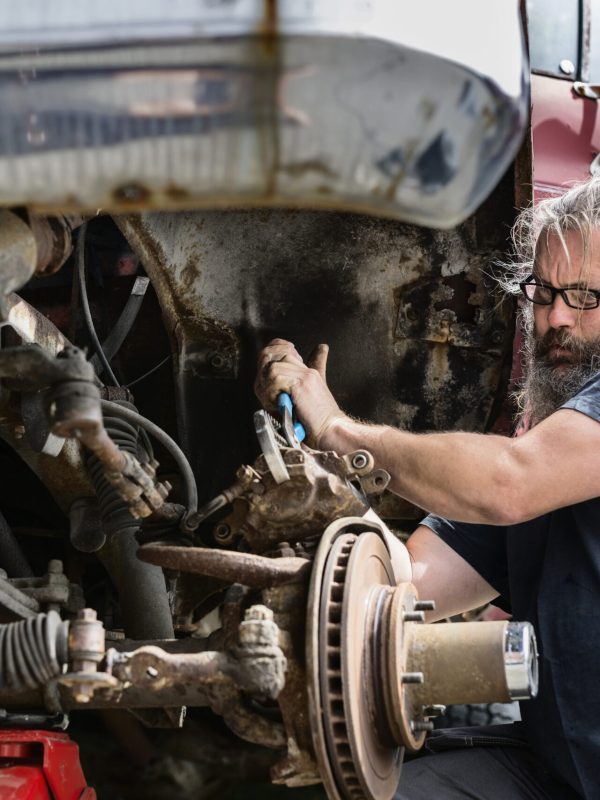 Mature man repairing car